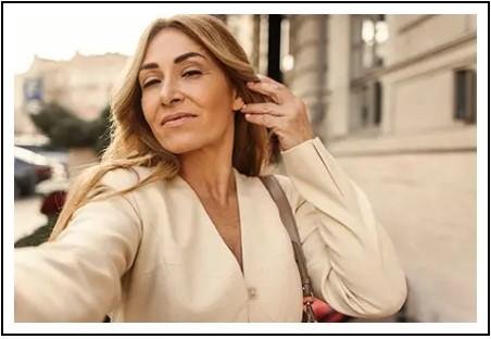 Confident woman outdoors in a natural setting, representing a healthy and balanced lifestyle.